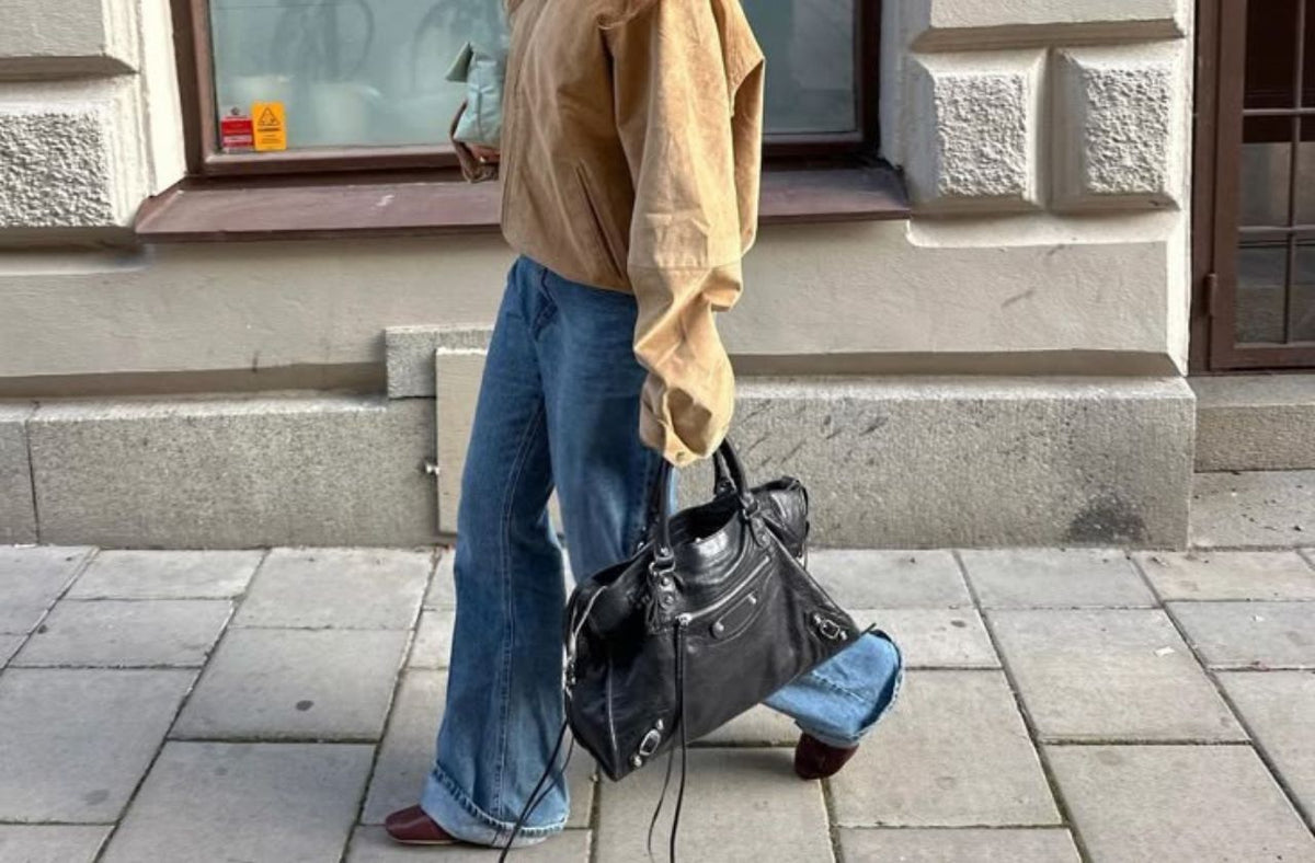 women wearing baggy jean with beige jacket on street