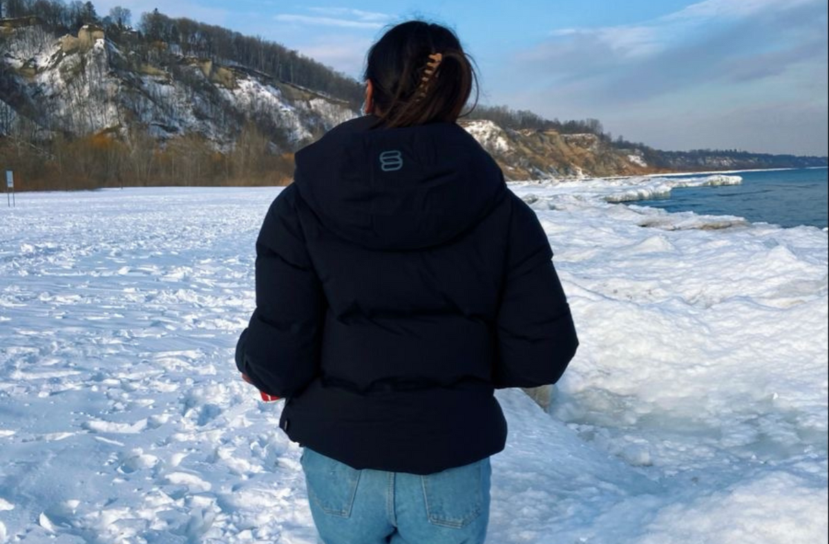 women in the snow wearing black puffer jacket