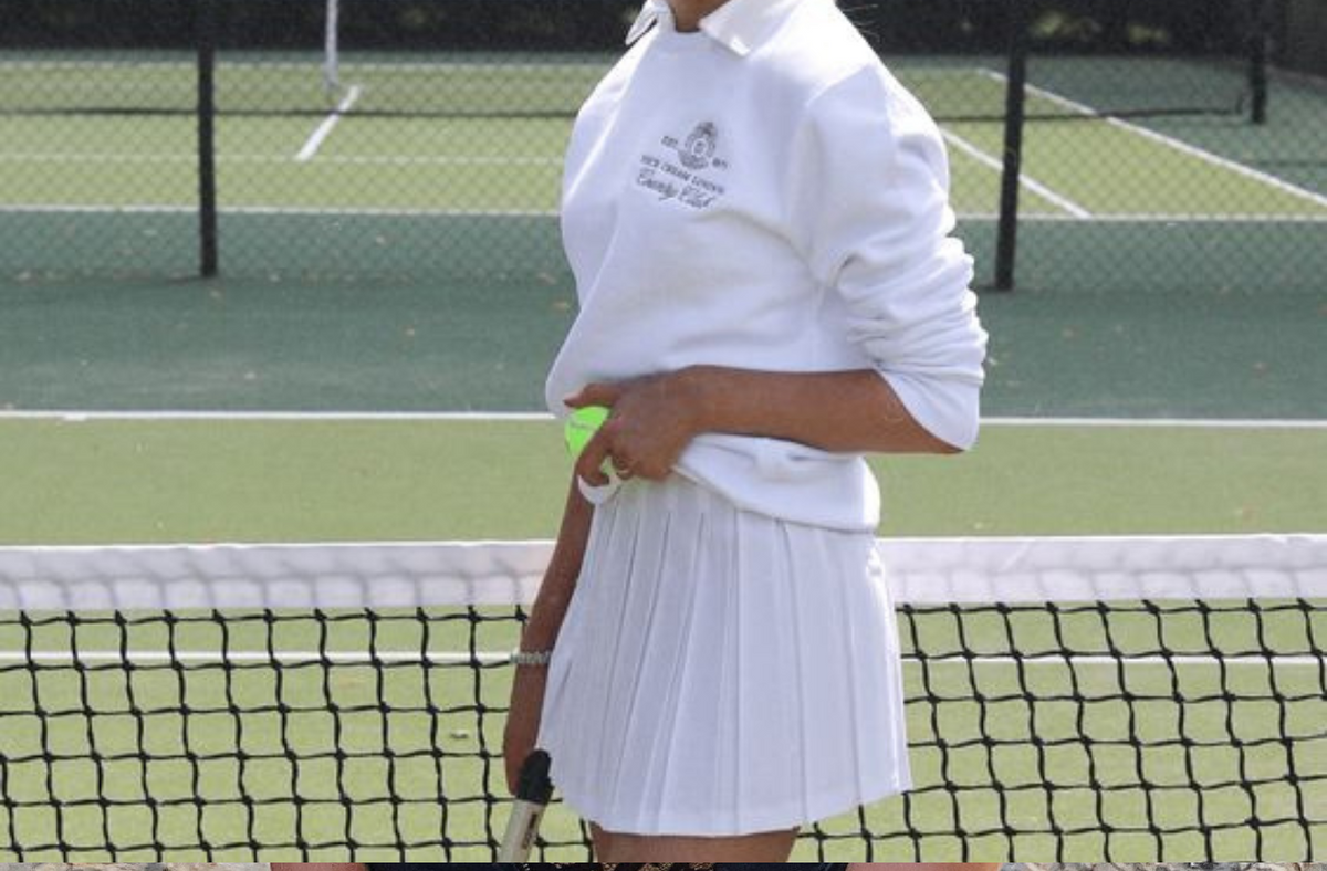 women playing tennis on tennis court