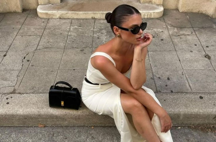 women in the streets of paris wearing chic white dress and sunglasses