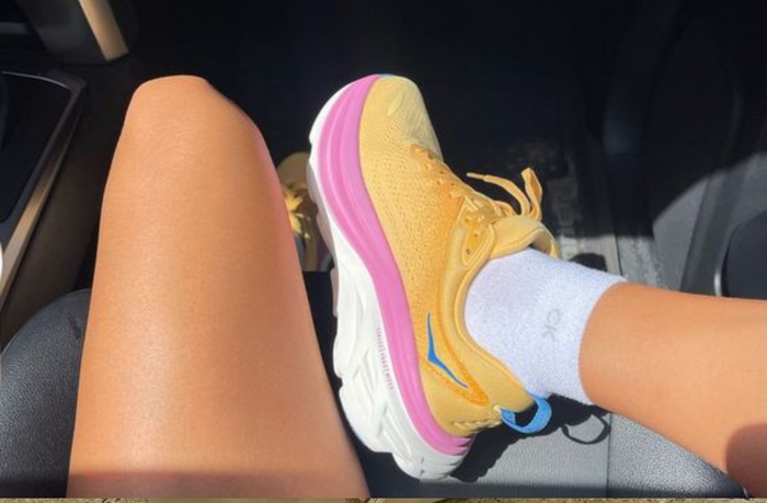women wearing running shoes with long sock in the car
