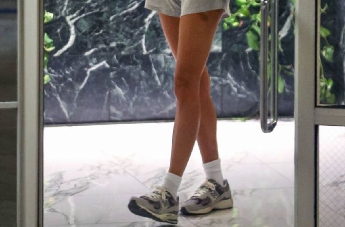 women walkig in europe wearing new balance sneakers with shorts and tank top