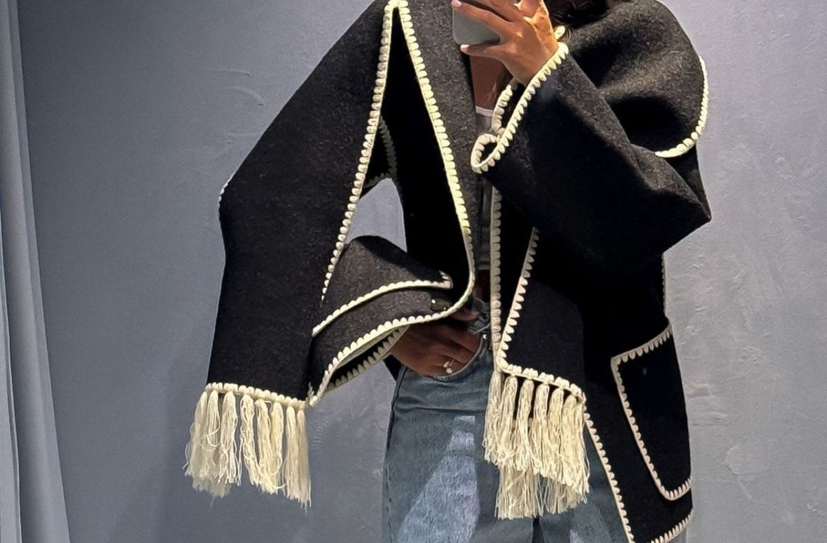 women wearing toteme scarf jacket with denim jeans and boots