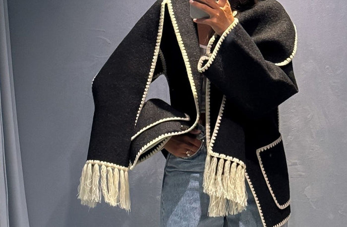 women wearing toteme scarf jacket with denim jeans and boots